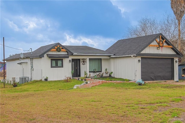 view of front of house with a garage, a front yard, and central air condition unit