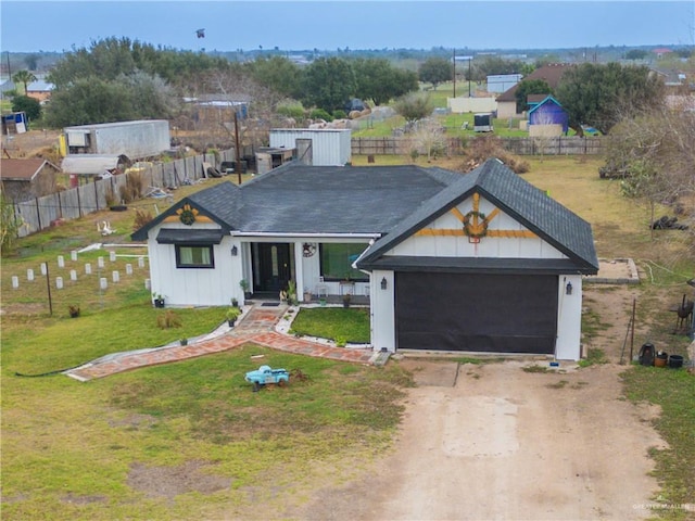 view of front of home with a garage and a front yard