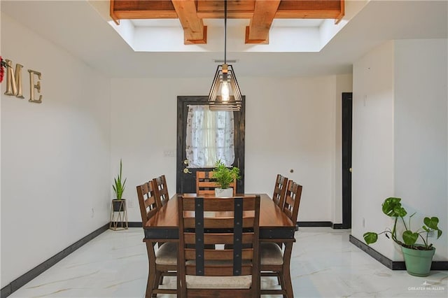 dining area featuring beam ceiling