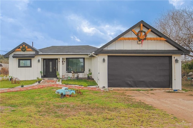 view of front of home with a garage and a front lawn