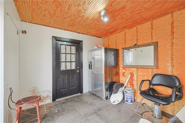 kitchen featuring stainless steel fridge and wooden ceiling