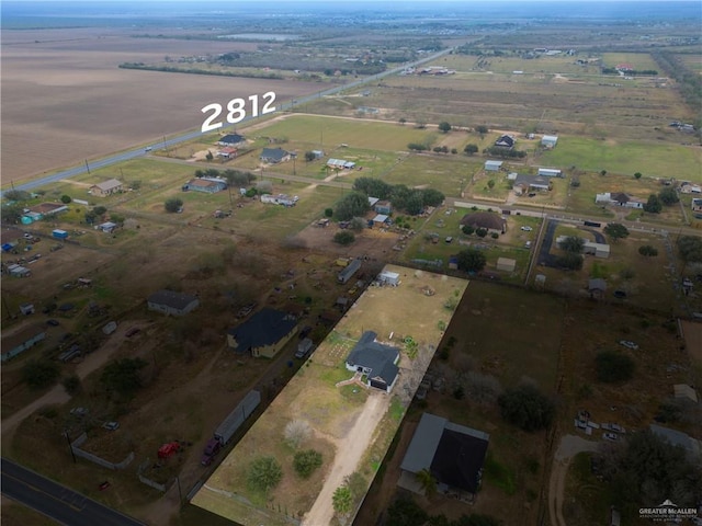 birds eye view of property featuring a water view and a rural view