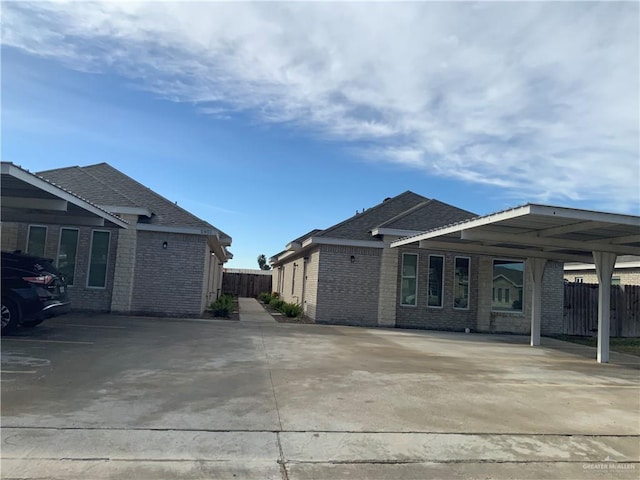 view of side of home with a carport