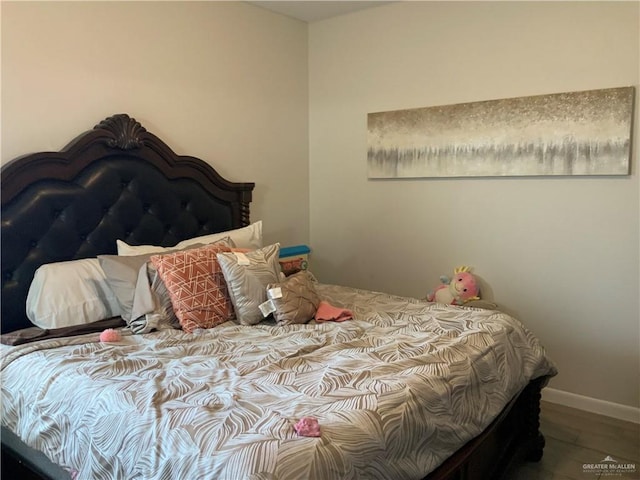 bedroom with hardwood / wood-style flooring