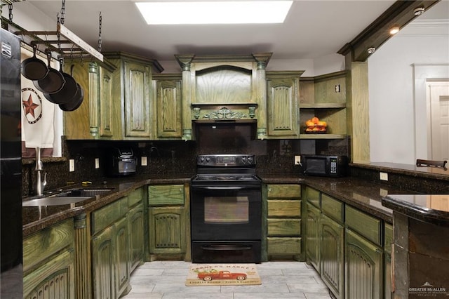 kitchen featuring black appliances, decorative backsplash, sink, and green cabinetry