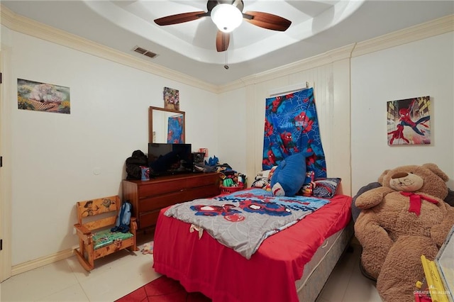 bedroom with light tile patterned floors, a tray ceiling, ceiling fan, and crown molding