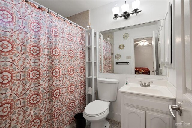 bathroom featuring a shower with curtain, vanity, and toilet