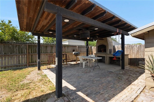 view of patio / terrace with an outdoor stone fireplace