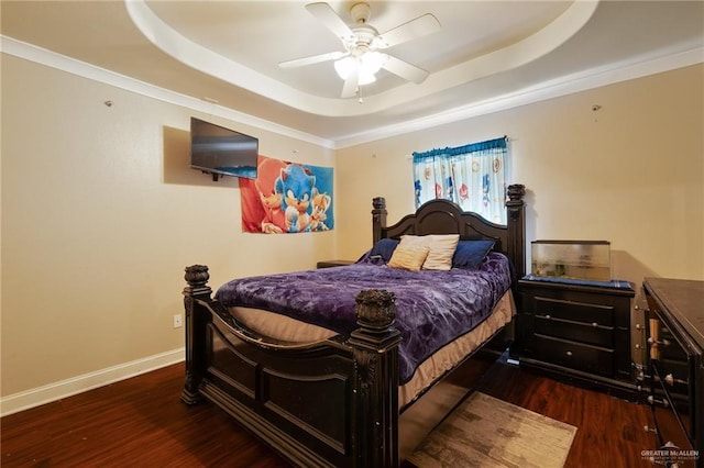 bedroom featuring dark hardwood / wood-style flooring, a raised ceiling, ceiling fan, and crown molding