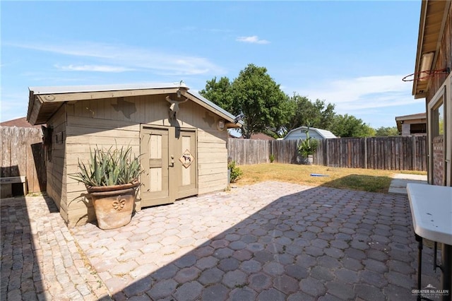 view of patio with a storage shed