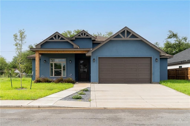 view of front of property with a garage and a front lawn