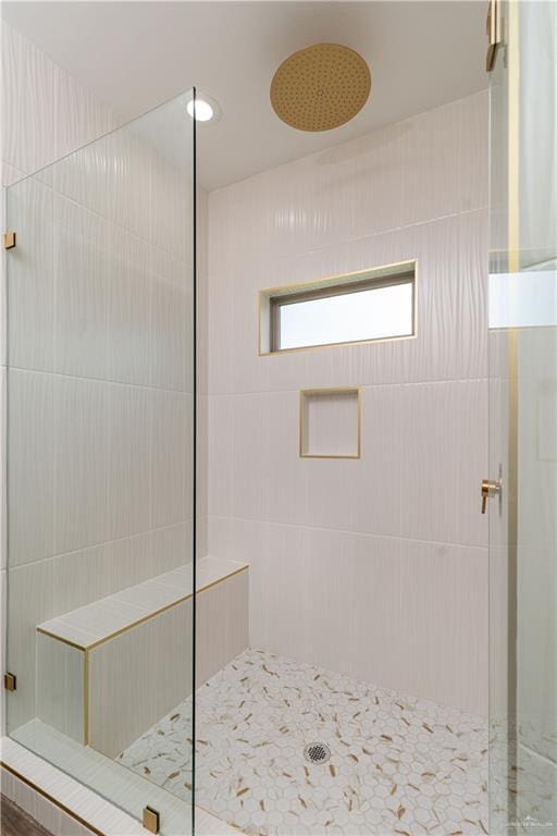 bathroom with a tile shower