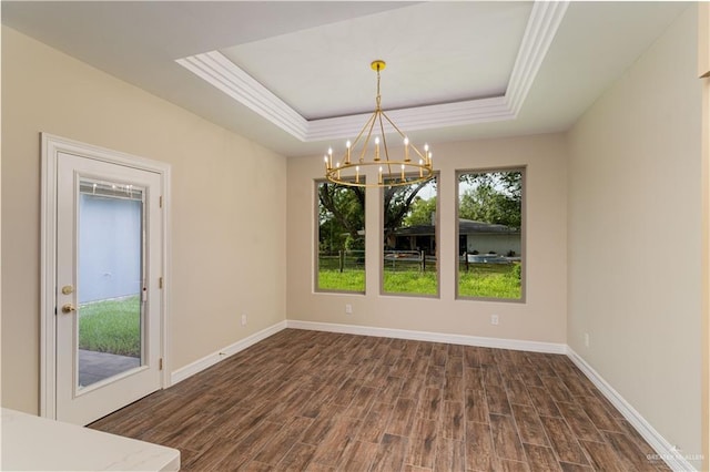 unfurnished dining area featuring a raised ceiling, a notable chandelier, and dark hardwood / wood-style flooring