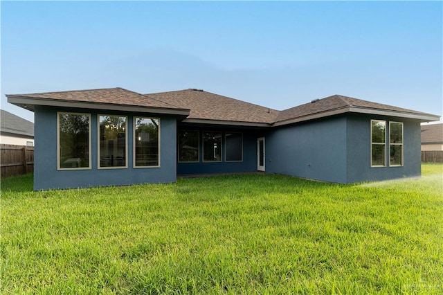 rear view of house with a lawn