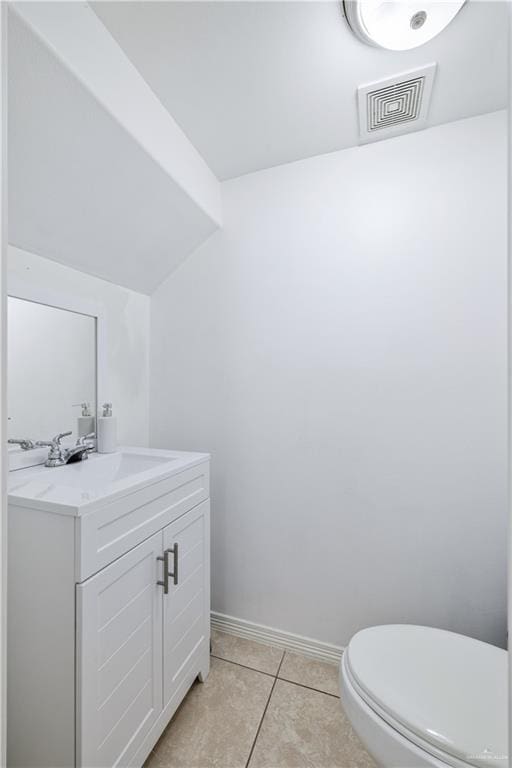 1041 Yellow Hammer St, Rio Grande City, TX 78582 - half bath with vanity, toilet, baseboards, and tile patterned floors