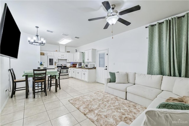 1041 Yellow Hammer St, Rio Grande City, TX 78582 - living room featuring a chandelier, a ceiling fan, light tile patterned flooring, and baseboards