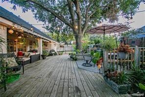 wooden terrace with an outdoor living space