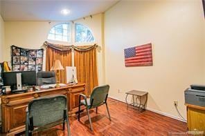 home office featuring hardwood / wood-style flooring and vaulted ceiling