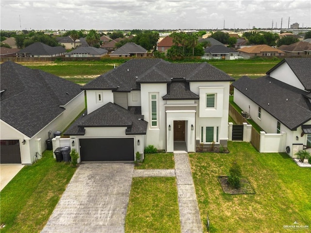 view of front of house featuring a garage and a front yard