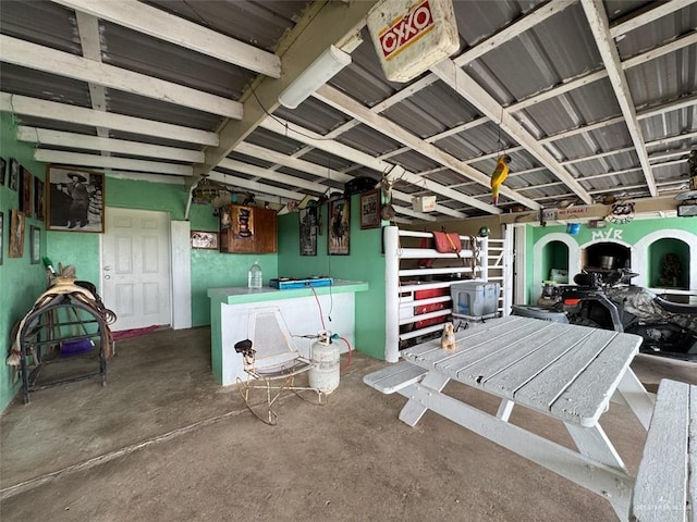 interior space with unfinished concrete flooring and a garage