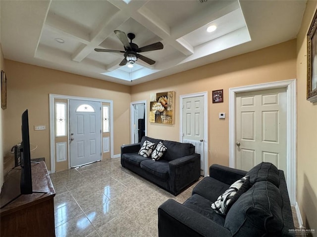 living area featuring baseboards, ceiling fan, coffered ceiling, and beam ceiling