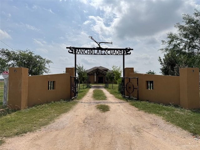 view of road featuring driveway and a gated entry