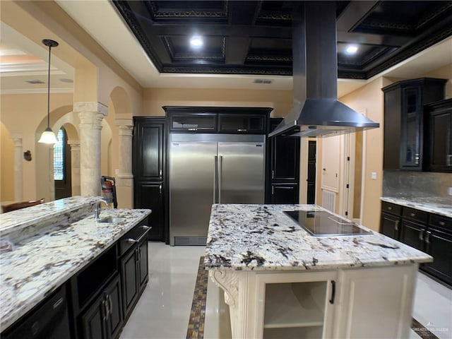kitchen with arched walkways, black electric stovetop, built in fridge, ornamental molding, and ornate columns