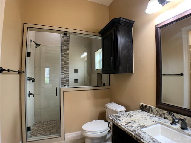 full bath with toilet, a stall shower, and vanity