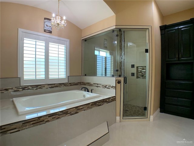bathroom with an inviting chandelier, tile patterned flooring, a bath, a stall shower, and lofted ceiling