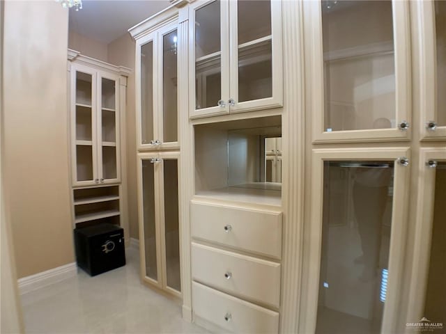 walk in closet with tile patterned flooring