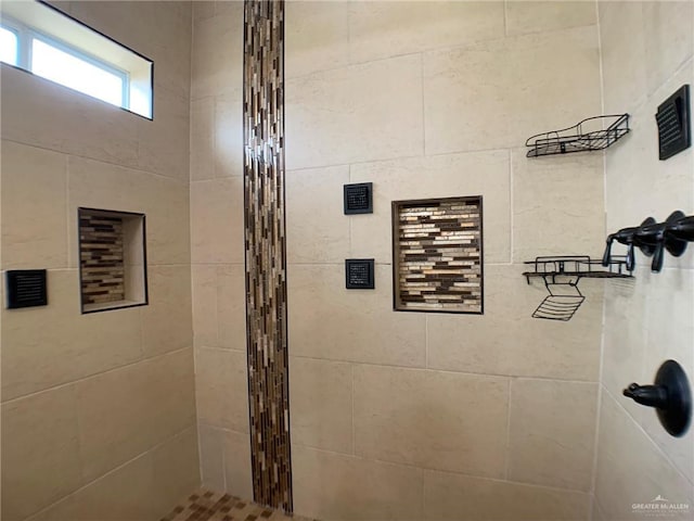 full bathroom with tiled shower
