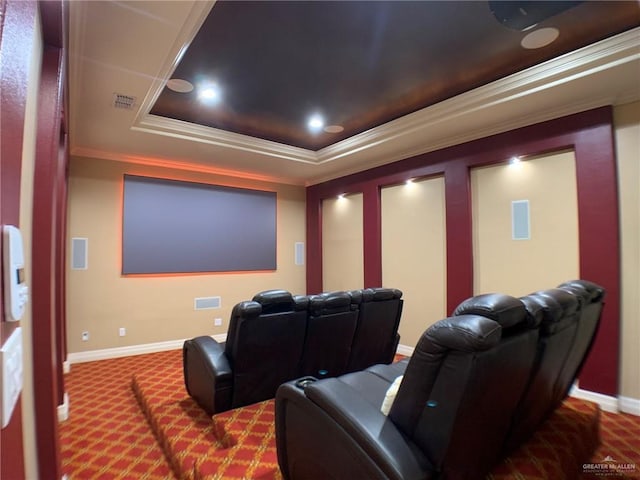 home theater featuring carpet flooring, a raised ceiling, crown molding, visible vents, and baseboards