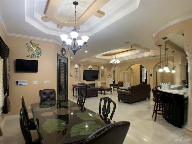 dining area with arched walkways, a notable chandelier, crown molding, and a tray ceiling