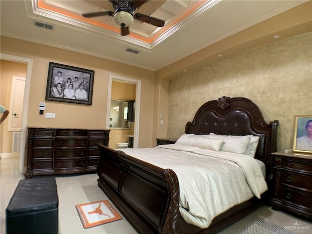 bedroom with visible vents, crown molding, and a tray ceiling