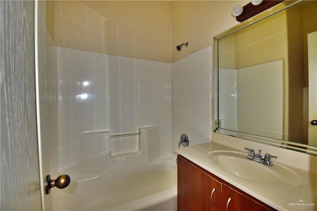 bathroom featuring vanity and  shower combination