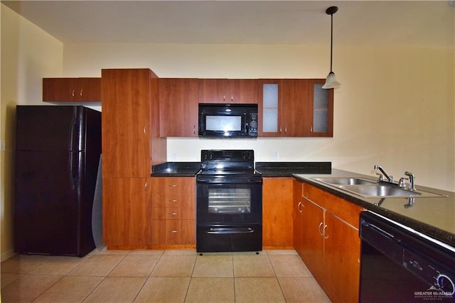 kitchen featuring light tile patterned flooring, sink, pendant lighting, and black appliances