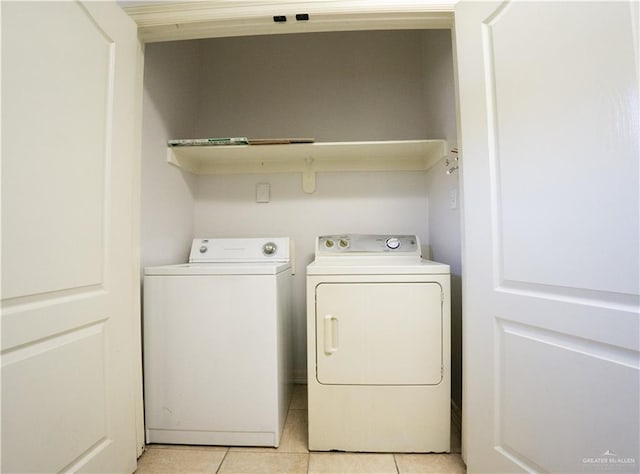 laundry room featuring separate washer and dryer and light tile patterned floors