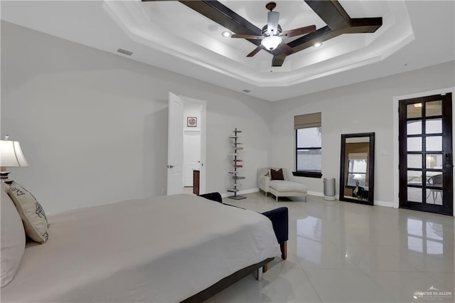 bedroom featuring a tray ceiling and ceiling fan