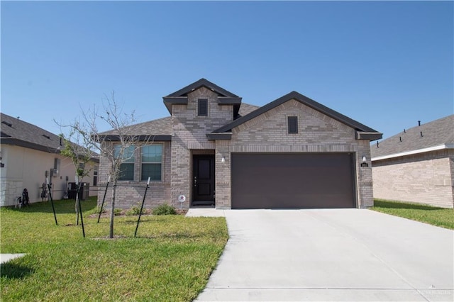 3413 Emory Ave, Mcallen, TX 78504 - view of front of home with an attached garage, driveway, brick siding, and a front yard