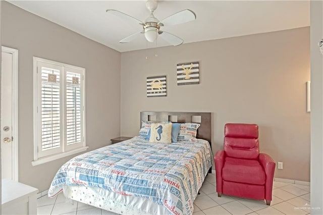 tiled bedroom featuring a ceiling fan