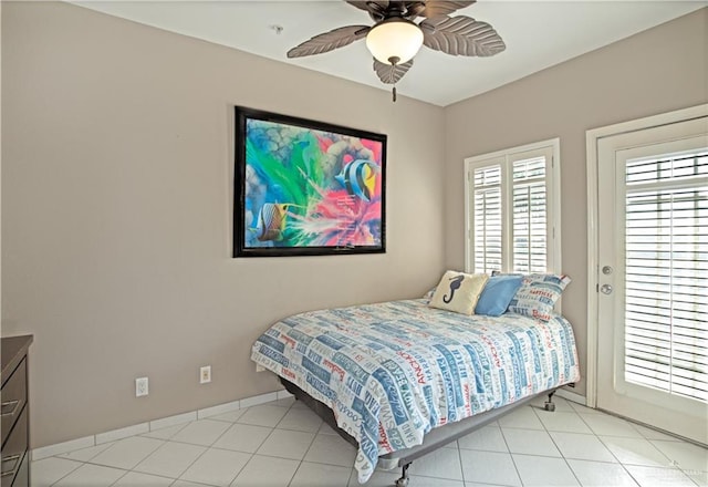bedroom with baseboards, a ceiling fan, light tile patterned flooring, and access to exterior