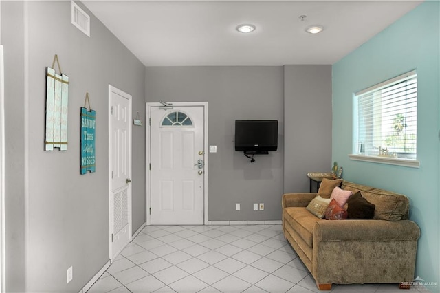 entrance foyer featuring baseboards, light tile patterned flooring, and visible vents