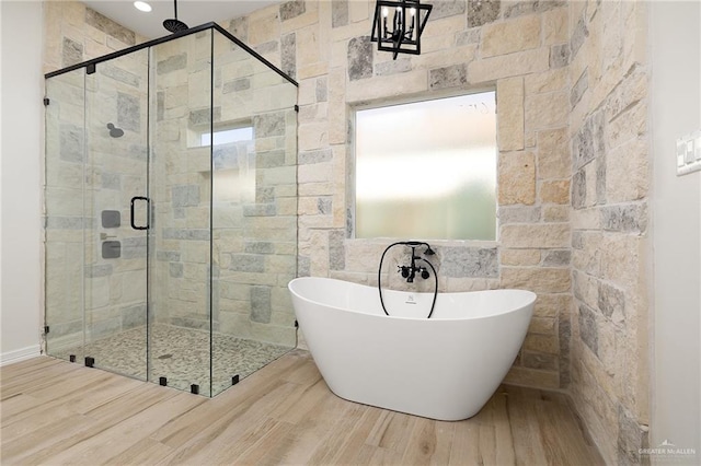 bathroom featuring hardwood / wood-style flooring and independent shower and bath