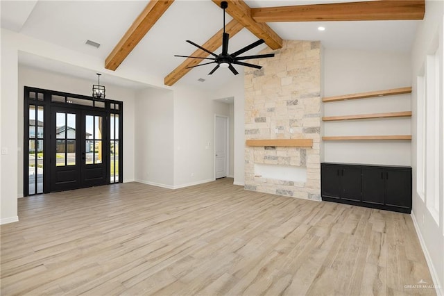 unfurnished living room featuring ceiling fan, french doors, beamed ceiling, high vaulted ceiling, and light wood-type flooring