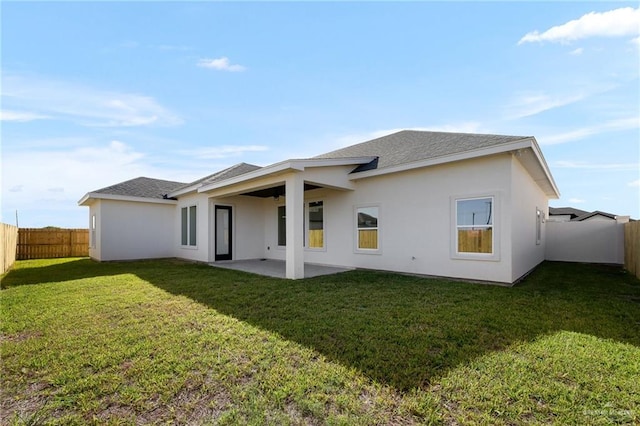 back of property featuring a patio area and a yard