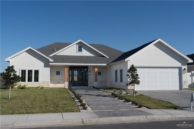 view of front of property with a garage and a front yard