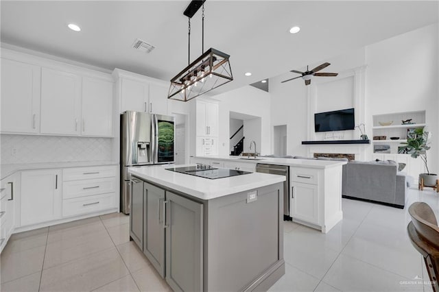 2800 Santa Lydia St, Mission, TX 78572 - kitchen featuring appliances with stainless steel finishes, a sink, a center island, light countertops, and light tile patterned floors