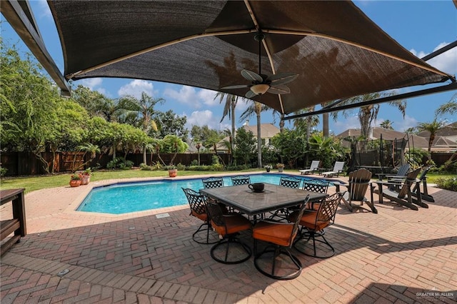 2800 Santa Lydia St, Mission, TX 78572 - view of pool featuring a patio, a fenced backyard, a ceiling fan, and a trampoline