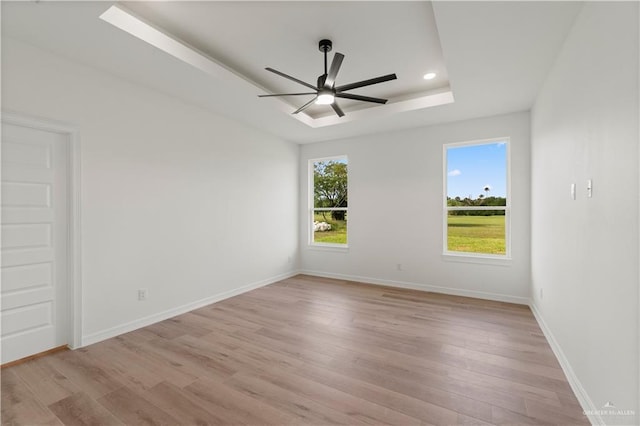 1114 Knotty Pine Ln, Harlingen, TX 78552 - spare room with light wood-style flooring, ceiling fan, a raised ceiling, and recessed lighting