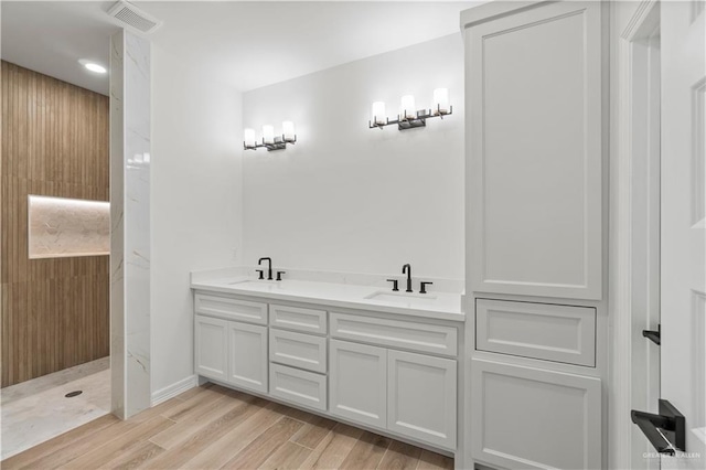 1114 Knotty Pine Ln, Harlingen, TX 78552 - bathroom featuring wood finished floors, double vanity, recessed lighting, and a shower
